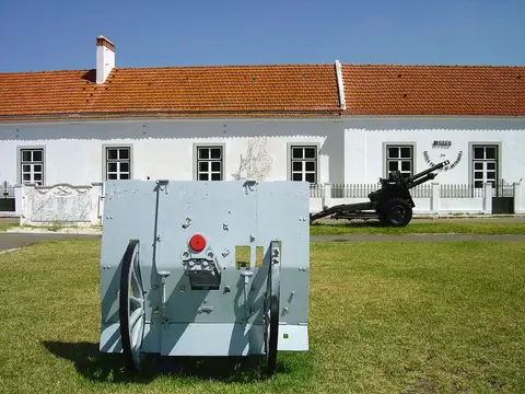 Peças de artilharia expostas no relvado diante do edifício branco do Museu da Escola Prática de Artilharia