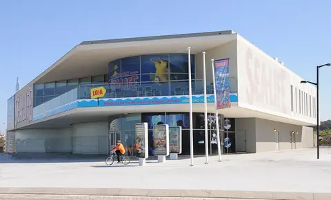 Edifício moderno do Sea Life Porto com letreiro e cartazes, visto do exterior em dia de sol