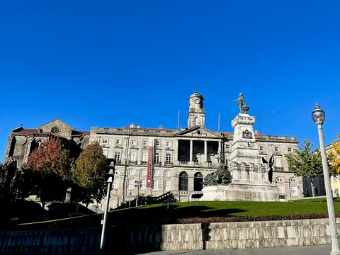 Fachada do Palácio da Bolsa no Porto com o monumento a Infante D. Henrique em primeiro plano