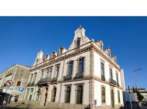 Fachada do edifício histórico da Biblioteca Municipal de Estarreja sob céu azul