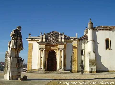 Pátio da Universidade de Coimbra com estátua de D. João III e fachada barroca ao fundo